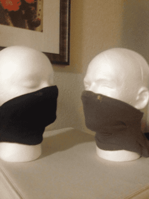 Two mannequins wearing face masks.