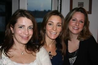 Three women smiling for a photo.